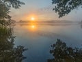 Beautiful sunrise over misty lake. Royalty Free Stock Photo