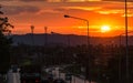 Beautiful sunrise over mountain in the morning with birds flying. Big sun rise in the morning among clouds. Car and truck driving Royalty Free Stock Photo