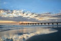 Beautiful sunrise over ocean horizon and pier. Royalty Free Stock Photo