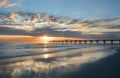 Beautiful sunrise over ocean horizon and pier. Royalty Free Stock Photo