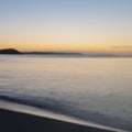 Beautiful sunrise over Pentewan Sands in Cornwall with pastel sky and long exposure ocean Royalty Free Stock Photo