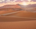 A beautiful sunrise over sand dunes in Namibia.