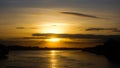 Beautiful sunrise over tree a summer morning and the river or lake and clouds reflected in calm water Royalty Free Stock Photo