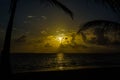 Beautiful sunrise on Punta Cana beach with the sun reflecting on the sea and the wet sand