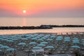Beautiful sunrise on Rimini beach with umbrellas Royalty Free Stock Photo