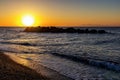 Beautiful sunrise with rocks in the sea at Kamari beach Santorini Royalty Free Stock Photo