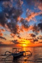 Beautiful sunrise scenery with Jukung is traditional balinese fishing boats at Karang Beach, Sanur, Bali, Indonesia Royalty Free Stock Photo