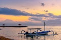 Beautiful sunrise scenery with Jukung is traditional balinese fishing boats at Karang Beach, Sanur, Bali, Indonesia Royalty Free Stock Photo