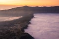 Beautiful sunrise with sea of fog at Cemoro Lawang village at mount Bromo volcano in, East Java, Indonesia