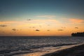 Beautiful sunrise at sea. Last minutes before dawn on the Atlantic ocean. The sun beyond horizon. Palm trees against the Royalty Free Stock Photo