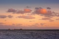 Beautiful sunrise at sea. Last minutes before dawn on the Atlantic ocean. The sun beyond horizon. Palm trees against the Royalty Free Stock Photo