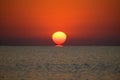 Beautiful sunrise at sea. The sun rises from the sea. The calm sea