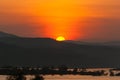 Beautiful sunrise sun behide river and mountain Royalty Free Stock Photo