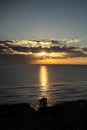 Beautiful sunrise with a tractor silhouette working near the sea in Cyprus