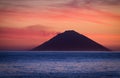 Beautiful sunrise withe the Stromboli volcano seen from the Salina island in the Aeolian islands, Sicily, Italy Royalty Free Stock Photo