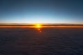 Beautiful sunset above clouds. View from inside of airplane Royalty Free Stock Photo