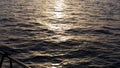 Beautiful sunset above the sea and the deck of the yacht edge. Stock. Stunning seascape, ripple in the see and the sun Royalty Free Stock Photo