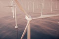 Beautiful sunset above the wind turbines in sea, ocean. Clean energy, wind energy, ecological concept. 3d rendering Royalty Free Stock Photo