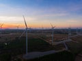 Beautiful sunset above the windmills on the field. Royalty Free Stock Photo