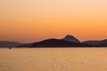 Beautiful sunset on the Aegean Sea with islands and a boat. Seascape, travel and nature concept Royalty Free Stock Photo