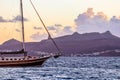Beautiful sunset on the Aegean Sea with mountains and a sailboat. Seascape, travel and nature concept Royalty Free Stock Photo