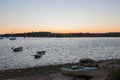 Beautiful sunset at Alvor harbour. Boats, calm water and orange sky. Portimao, Algarve, Portugal