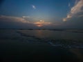 beautiful sunset on the beach with blue cloudy sky and water waves tides