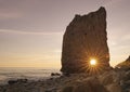 Beautiful Sunset on Beach. Catch the Sun Trough the Hole