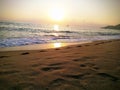 Beautiful sunset on the beach. Tracks in the sand