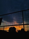 Beautiful sunset behind a high fence with overcast clouds in Playen, Indonesia Royalty Free Stock Photo