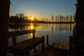 Beautiful sunset and bench on river Kymijoki in February, Finland Royalty Free Stock Photo