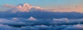 Beautiful sunset in the Caucasus Mountains, view towards Elbrus from the Bermamyt plateau. Snow-capped peaks above the clouds Royalty Free Stock Photo