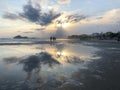 Beautiful sunset with clouds against the blue sky. In the background the sea, mountains, sand. Royalty Free Stock Photo