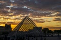 Beautiful sunset clouds over the Paris Louvre Museum with the pyramid silhouette Royalty Free Stock Photo