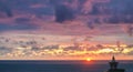 Beautiful sunset cloudy sky with view of sun and sea Royalty Free Stock Photo