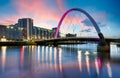 Beautiful Sunset Clyde Arc Bridge across river in Glasgow, Scotland, UK. It is nice weather with reflection on water, blue sky, Royalty Free Stock Photo