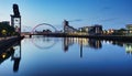 Beautiful Sunset Clyde Arc Bridge across river in Glasgow, Scotland, UK. It is nice weather with reflection on water, blue sky, Royalty Free Stock Photo