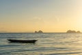 Beautiful sunset on the coast of a tropical island in Thailand, a silhouette of a boat in the ocean