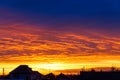 Beautiful sunset. Colorful dramatic sky at sunset. .The roofs of rural houses on the background of sunset. Royalty Free Stock Photo