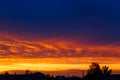 Beautiful sunset. Colorful dramatic sky at sunset. Layered rain clouds. Bright blue orange background. The texture of the sunset. Royalty Free Stock Photo