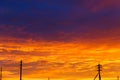Beautiful sunset. Antennas and pipes at sunset. Layered rain clouds. Bright blue orange background. The texture of the sunset. Royalty Free Stock Photo