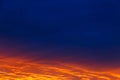 Beautiful sunset. Colorful dramatic sky at sunset. Layered rain clouds. Bright blue orange background Royalty Free Stock Photo