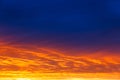 Beautiful sunset. Colorful dramatic sky at sunset. Layered rain clouds. Bright blue orange background Royalty Free Stock Photo