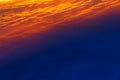 Beautiful sunset. Colorful dramatic sky at sunset. Layered rain clouds. Bright blue orange background Royalty Free Stock Photo