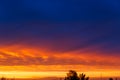 Beautiful sunset. Colorful dramatic sky at sunset. Layered rain clouds. Bright blue orange background Royalty Free Stock Photo