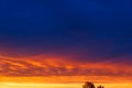 Beautiful sunset. Colorful dramatic sky at sunset. Layered rain clouds. Bright blue orange background Royalty Free Stock Photo