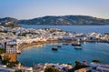 Beautiful sunset view over town of Mykonos, Greece and port. Golden hour, harbor, cruise ships, whitewashed houses Royalty Free Stock Photo