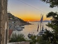 Beautiful sunset colors from the picturesque Hydra island in Greece. View from hydra town over the port