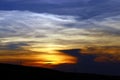 A beautiful sunset with dark clouds over a field Royalty Free Stock Photo