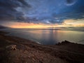 Beautiful sunset at Dead Sea, Jordan. Salt beach. Rays of lights